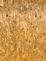 Compressed chipboard background. Wooden plank backdrop. OSB texture photo