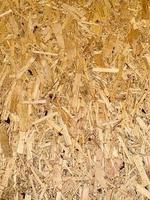 Compressed chipboard background. Wooden plank backdrop. OSB texture photo