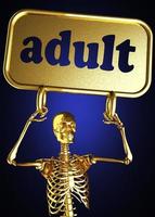 Golden skeleton holding the sign photo