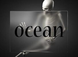 ocean word on glass and skeleton photo