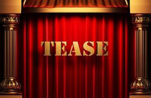 tease golden word on red curtain photo
