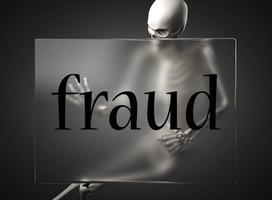 fraud word on glass and skeleton photo