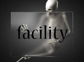 facility word on glass and skeleton photo