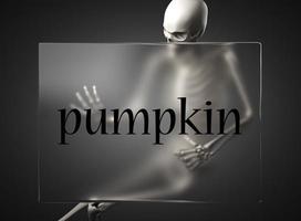 pumpkin word on glass and skeleton photo