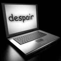 despair word on laptop photo