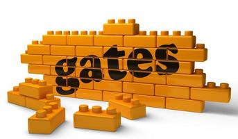 gates word on yellow brick wall photo