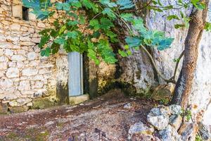 Door in the stone wall with stone stairs Cala Figuera. photo