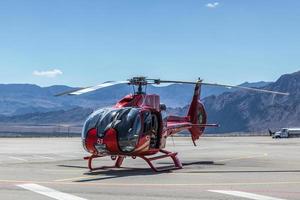 BOULDER CITY, NEVADA, USA, 2011. Red helicopter parked on the airfiled photo