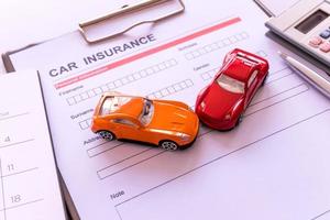 Car insurance form with model and policy document photo