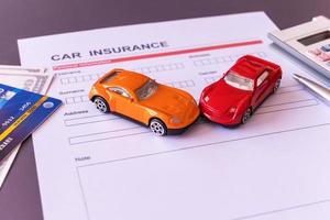 Car insurance form with model and policy document photo