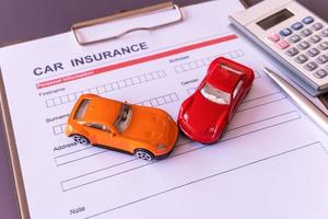 Car insurance form with model and policy document photo