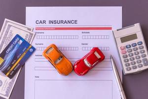 Car insurance form with model and policy document photo