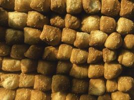 Odading, fried bread in cubes with a light brown crunchy outer skin and sprinkled with sesame seeds photo