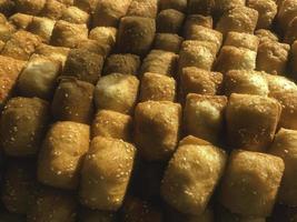 Odading, fried bread in cubes with a light brown crunchy outer skin and sprinkled with sesame seeds photo
