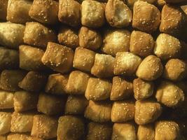 Odading, fried bread in cubes with a light brown crunchy outer skin and sprinkled with sesame seeds photo