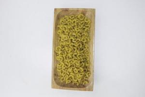 Top view of raw macaroni on white background. photo