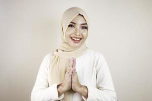 Portrait young beautiful Muslim woman wearing a hijab. Eid Mubarak greeting photo