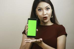 Asian beautiful girl is shocked by the smartphone with a redshirt photo