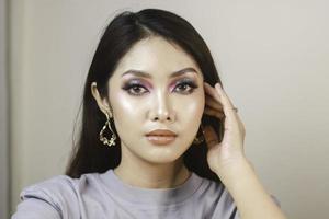 Conceptual beauty portrait of a beautiful young woman with colorful eyeshadow photo