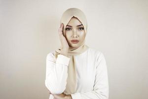 Tired beautiful Asian Muslim girl wearing a headscarf stressed out. photo