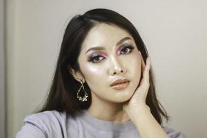 Conceptual beauty portrait of a beautiful young woman with colorful eyeshadow photo