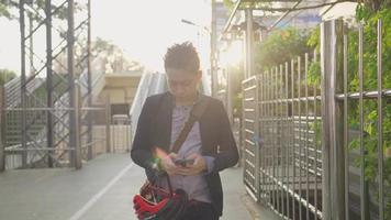 Young handsome business man checking on his phone for tomorrow plans, email, checklist, while walking back home after long meeting, feeling exhausted after hard working, living a healthy lifestyle. video