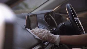 4k man hand disinfects his car, sprays wiping Steering Wheel, hand towel white cloth wipes, during the pandemic. Disinfection And Sanitizing, prevent infection of Covid-19 virus,contamination of germs video