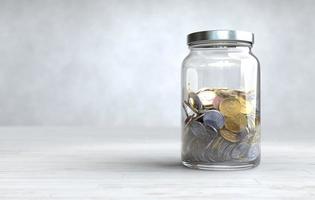 Coins in a glass jar, Money saving concept. photo