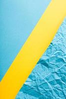 Simple paper flat lay background in blue and yellow colors. photo