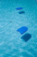Blue foam board for teaching swimming by the pool