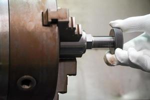 mechanic threads ring gauge on a CNC lathe. photo