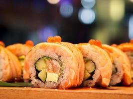 Sushi roll with salmon burned, delicious traditional japanese food photo