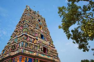 Traditional Hindu temple Kidangamparambu Sree Bhuvaneswari in India in Allapuzha Allepi Kerala. Tall building with colorful figures of Indian mythology and gods, flock of live birds. Tourism, travel