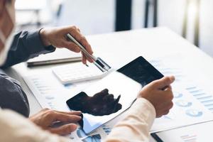Business Corporate team brainstorming, Planning Strategy having a discussion Analysis investment researching with chart at office his desk documents and saving concept. photo