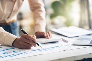 Accountant working with data documents calculating on business report, business financial and investment concept. photo