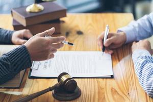 Consultation and conference of Male lawyers and professional businessman working and discussion having at law firm in office. Concepts of law, Judge gavel with scales of justice. photo