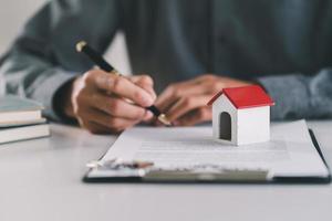 Male real estate agent hands counting money after successful deal for buying house. photo