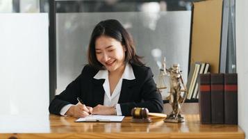 female lawyers working at the law firms. Judge gavel with scales of justice. Legal law, lawyer, advice and justice concept. photo