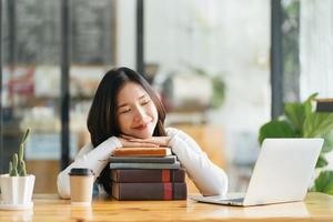 Preparing for university entrance. A tired girl fell asleep on stack of opened books photo