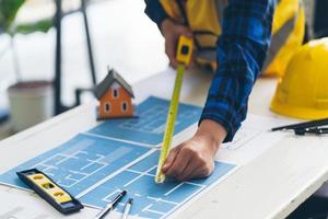 architect man working with blueprints,engineer inspection in workplace for architectural plan,sketching a construction project , architect and engineer concept. photo