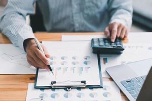 Financial businessman calculating corporate income tax data And analyzing charts of financial stocks that are in good condition with growth and progress, Investment in finance and accounting. photo
