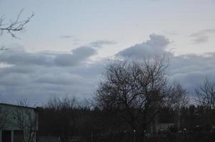 Thunderclouds in the evening on the sky in the village photo