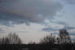 Thunderclouds in the evening on the sky in the village photo