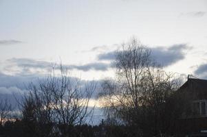 Thunderclouds in the evening on the sky in the village photo