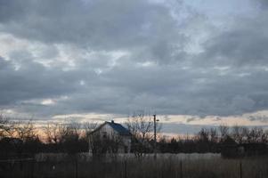 Thunderclouds in the evening on the sky in the village photo