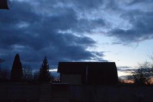 Thunderclouds in the evening on the sky in the village photo