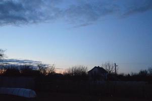 Thunderclouds in the evening on the sky in the village photo