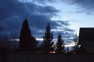 Thunderclouds in the evening on the sky in the village photo