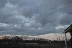 Thunderclouds in the evening on the sky in the village photo