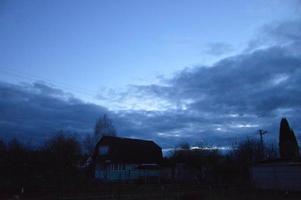 Thunderclouds in the evening on the sky in the village photo